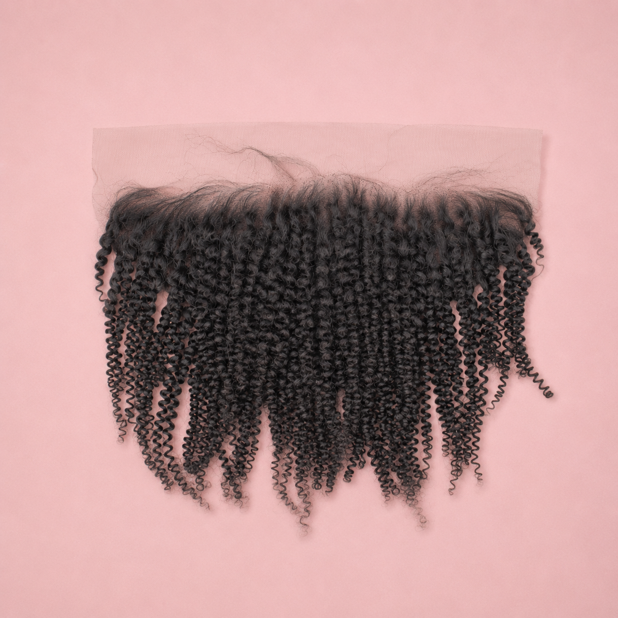Curly hair extensions on a pink background