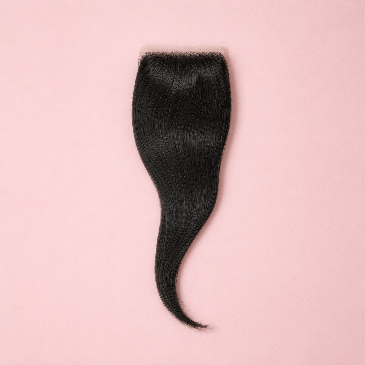 Black hair extension on a pink background