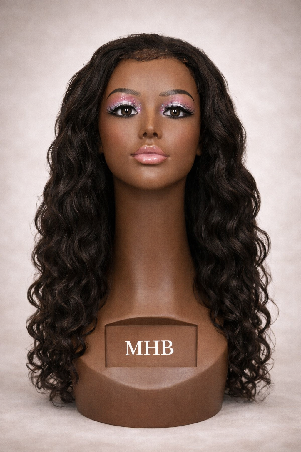 Mannequin head with long wavy black hair on a neutral background