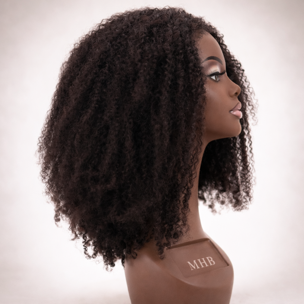 Mannequin head with curly hair styled wig on a plain background