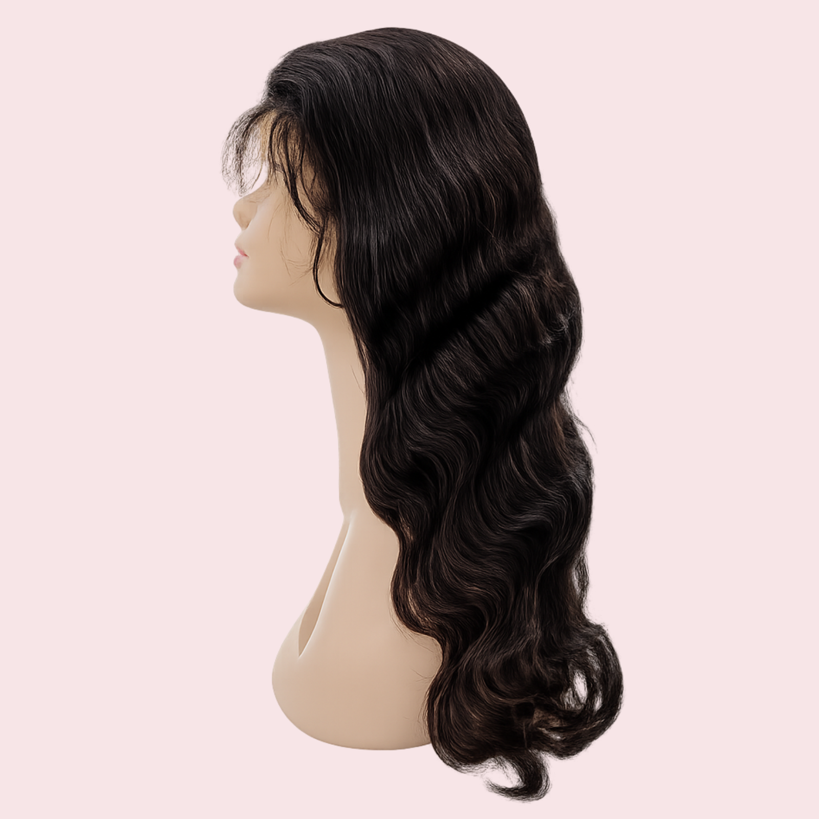 Black wavy wig on a mannequin head against a light pink background