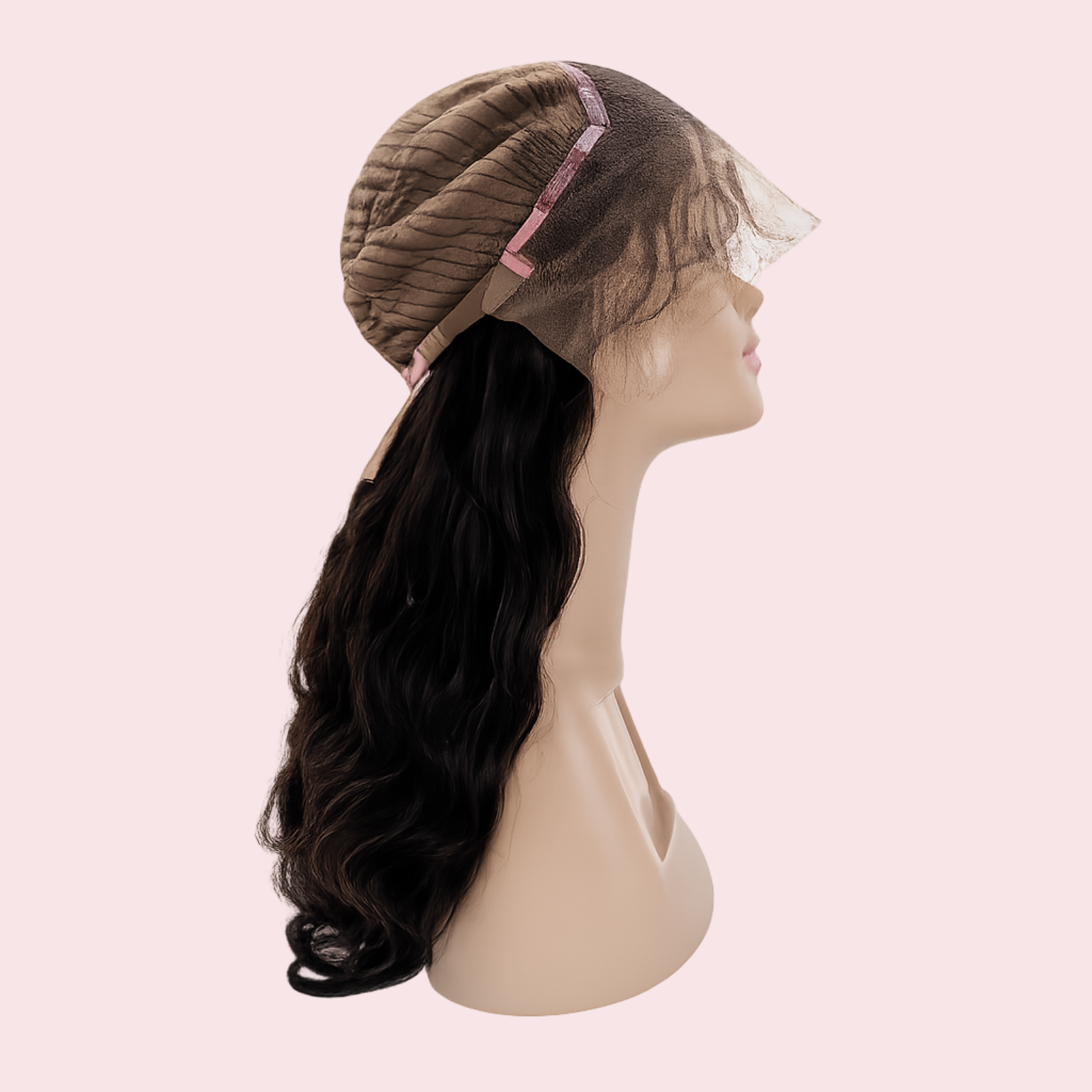 Mannequin head with a wig on a pink background