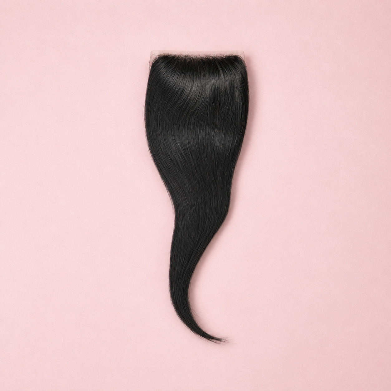 Black hair extension on a pink background