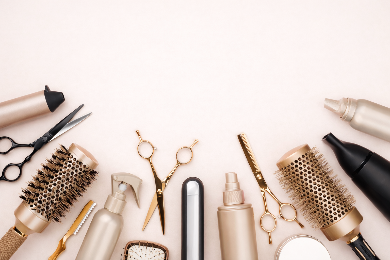 Collection of hair care and styling tools on a light background